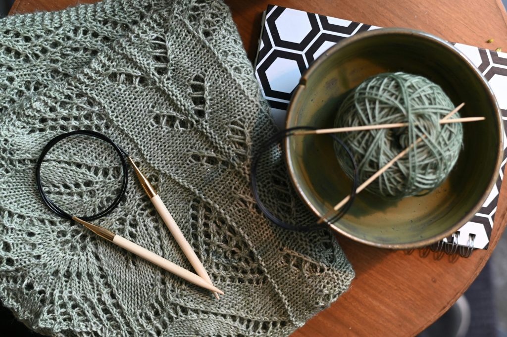 knitting vs crochet: two knitting needles and lacework knitting project